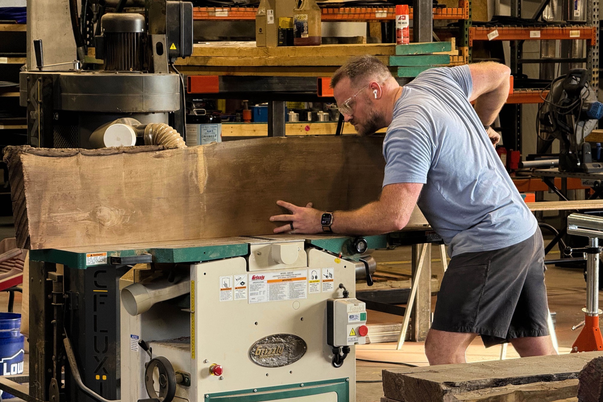 Cole Fisher milling a walnut slab at the jointer in the Wood Sugar Company shop