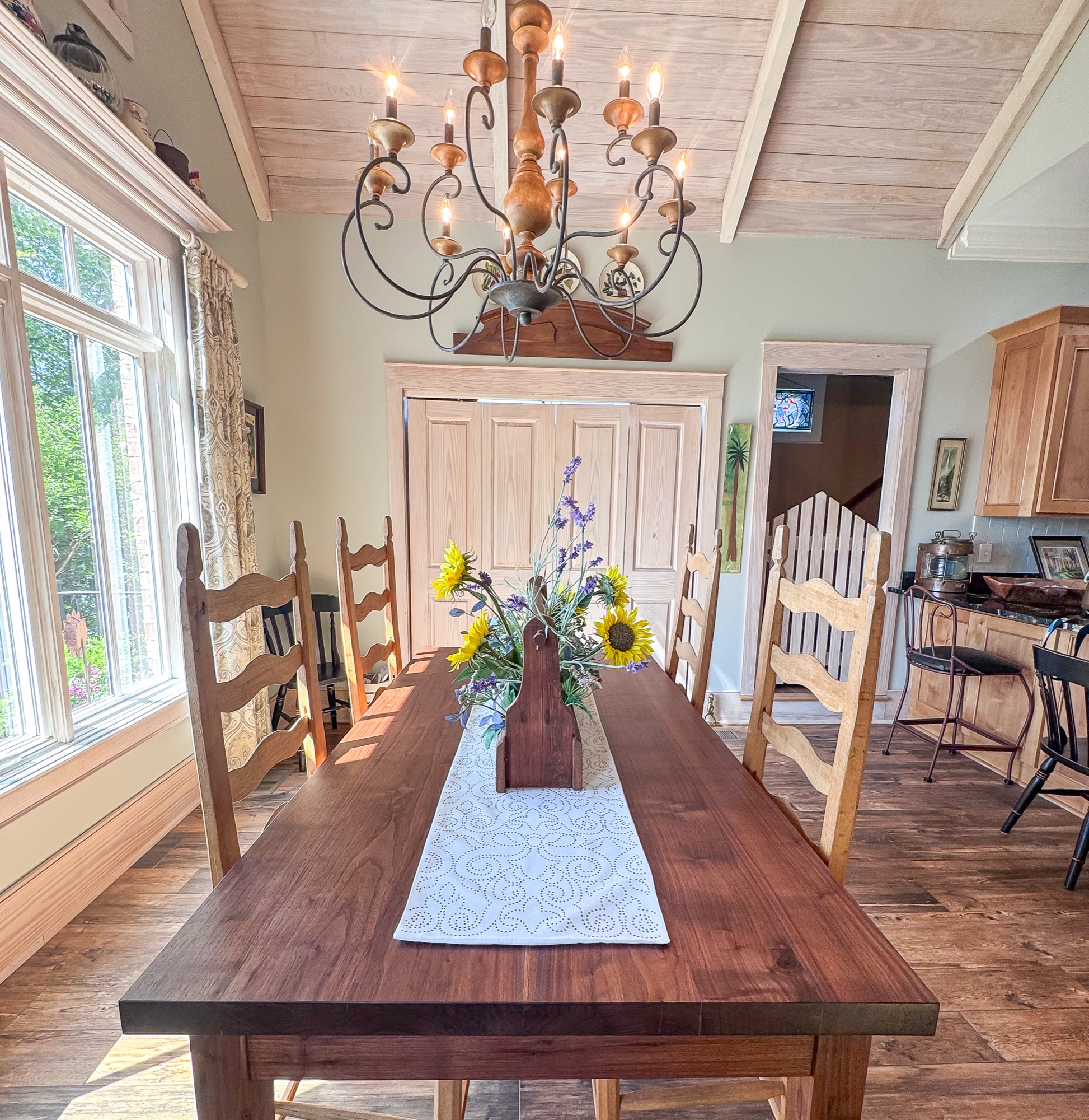 Solid black walnut dining table with ladder-back chairs