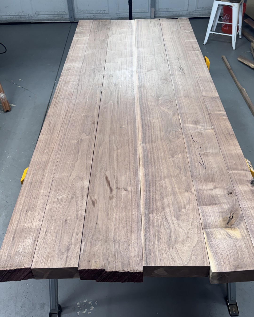Solid walnut table top laid up in the workshop