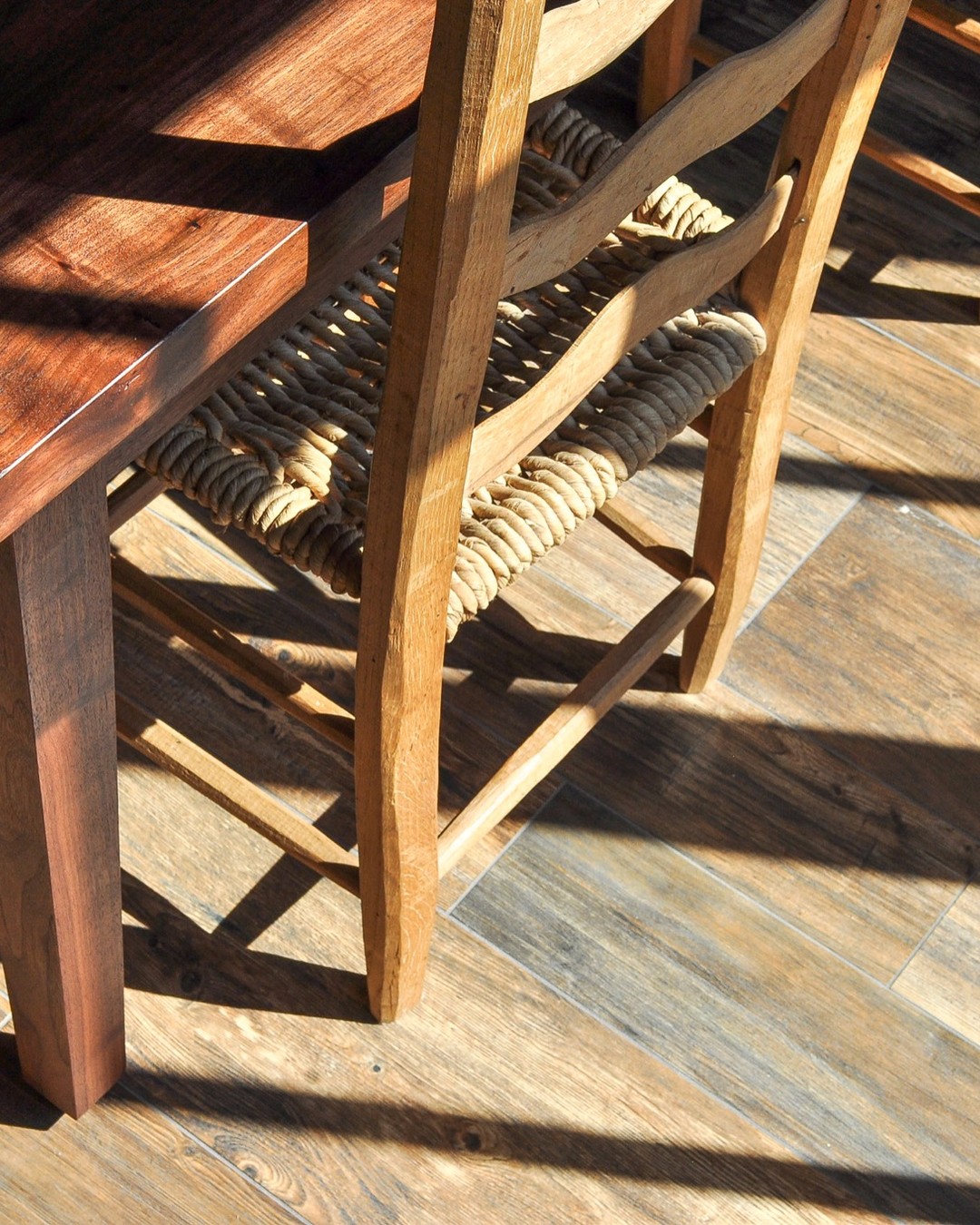 Tapered walnut leg and table edge in afternoon light